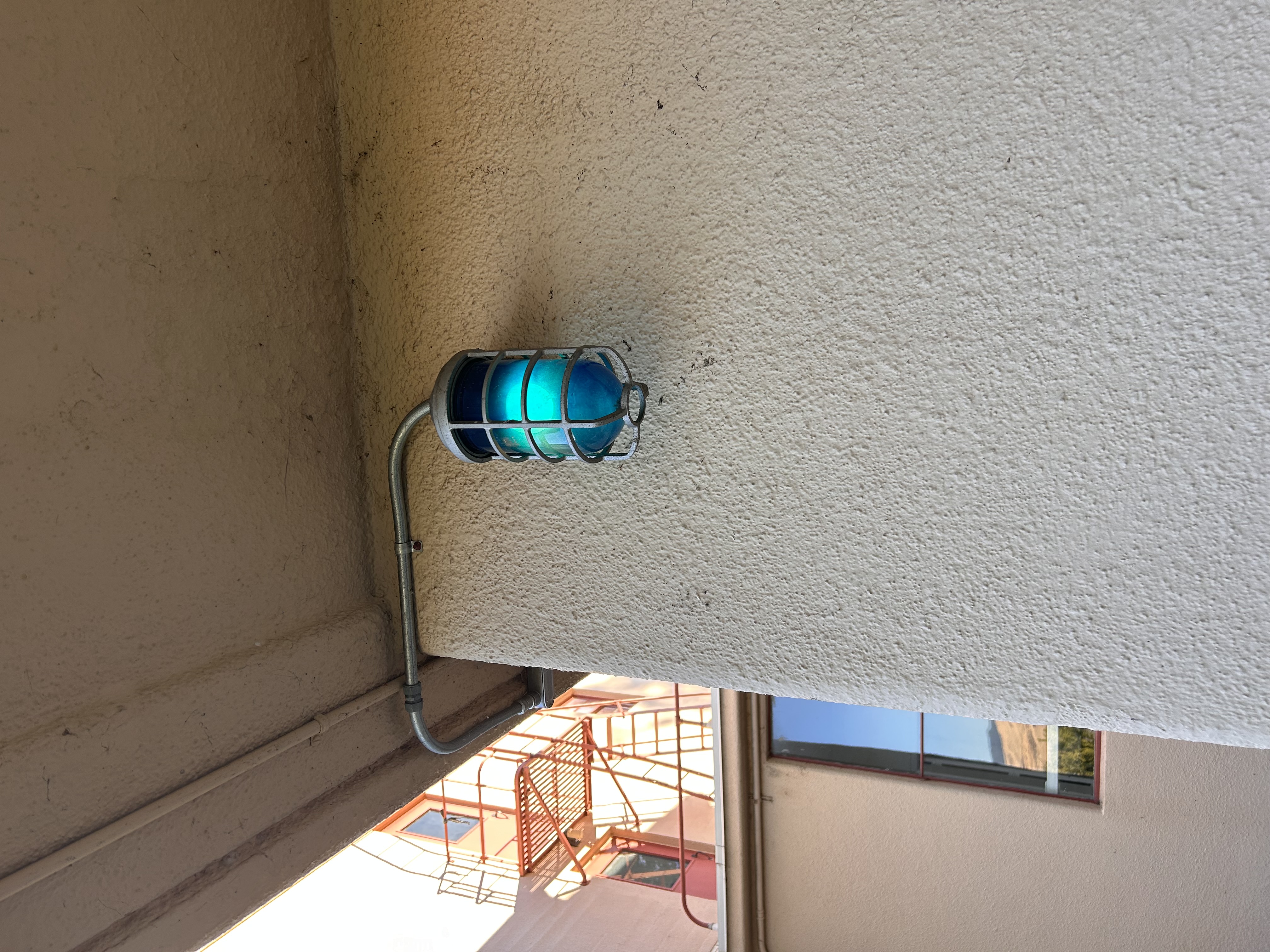 a cool teal light on the outside of one of the doorms